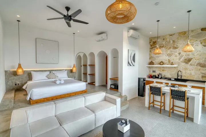 A light-filled living or kitchen space with pale finishes and timber furniture.