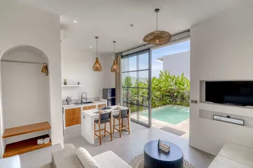 Kitchen island and living area beside glass doors opening onto the courtyard.